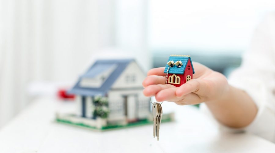 real estate agent with house model keys 1200x800 1