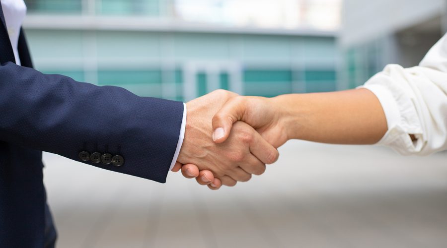 closeup shot business handshake cropped shot two people wearing formal suits shaking hands business handshake concept web