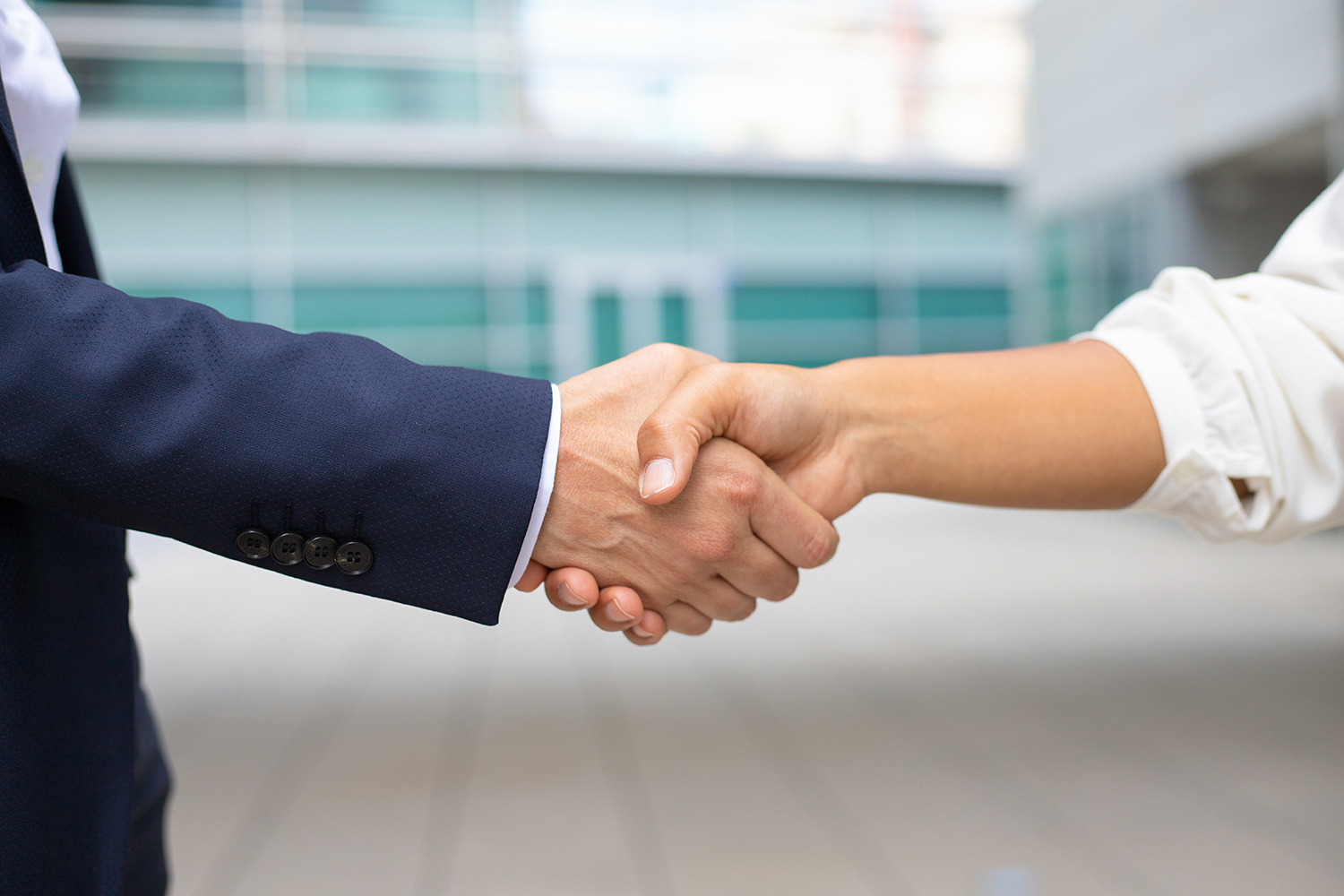 closeup shot business handshake cropped shot two people wearing formal suits shaking hands business handshake concept web
